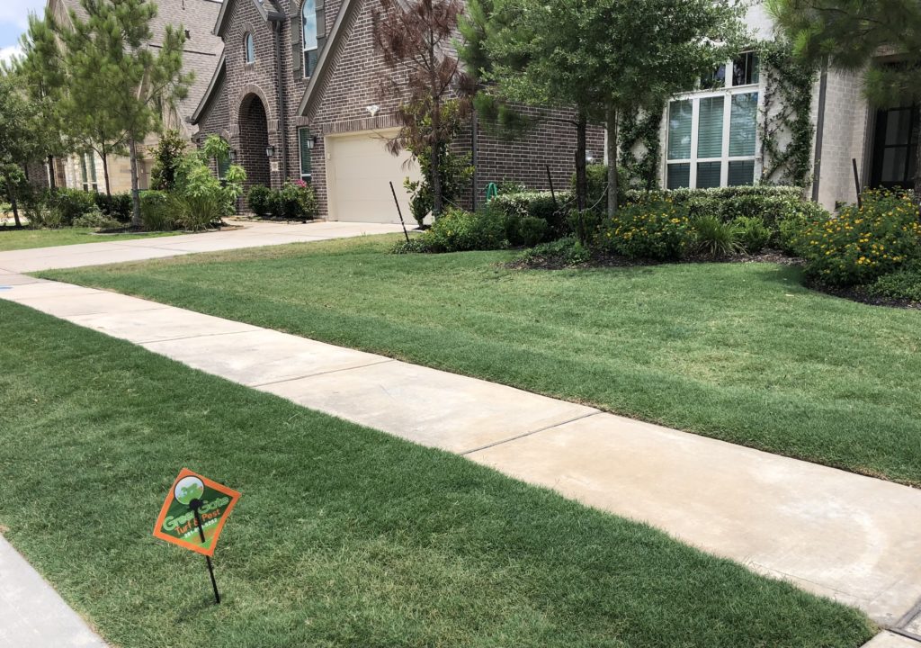 Green yard with a greengate turf & pest sign out front; Taken after a lawn service with chinch bug treatments