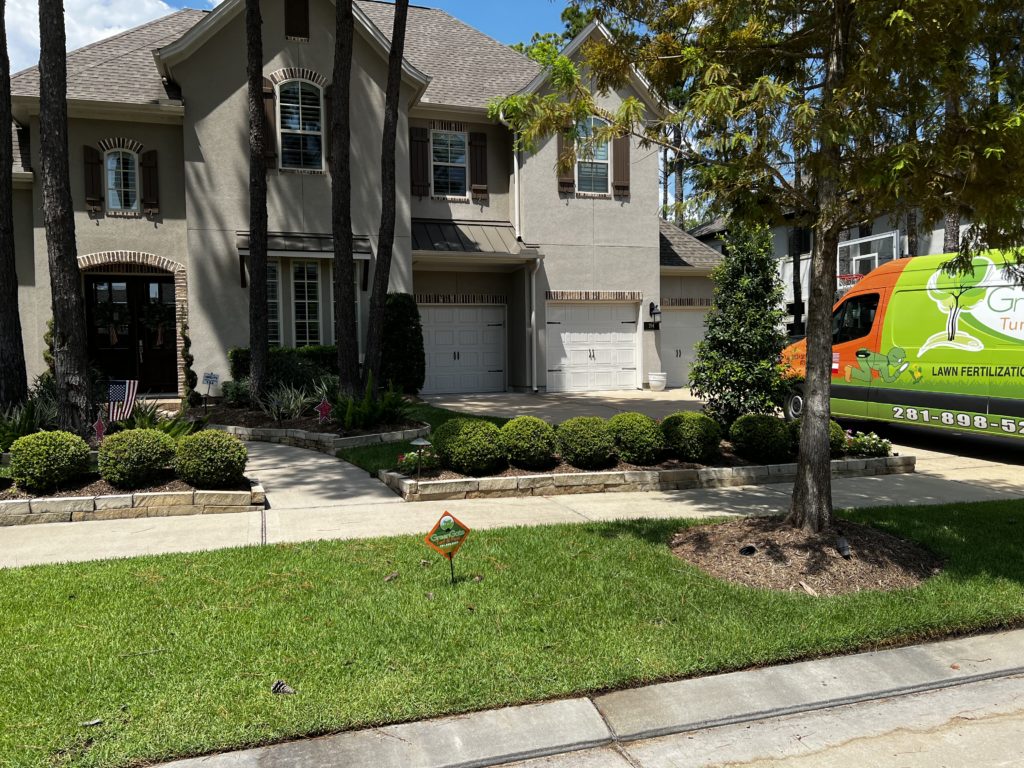 A big house promoting lawn fertilization services by GreenGate Turf & Pest in Houston, TX