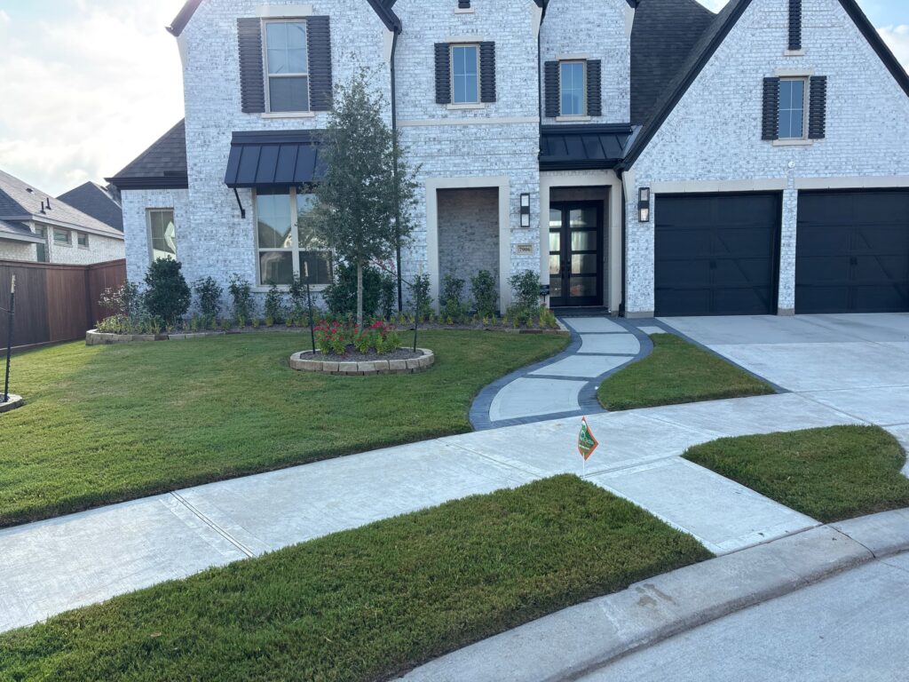 GreenGate Lawn sign in a green yard with flower beds; Technician completed Pest Control Service & Lawn Services