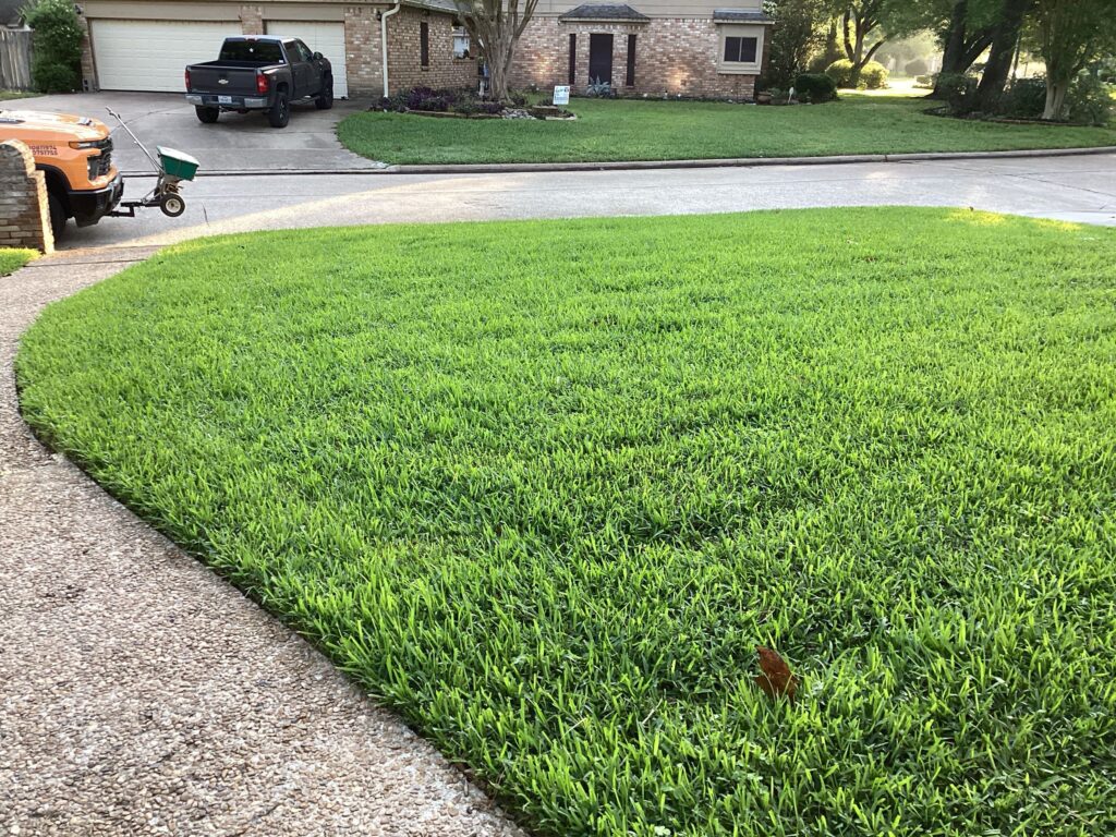 A Green lawn with a GreenGate truck parked outside after a lawn fertilization and weed control service