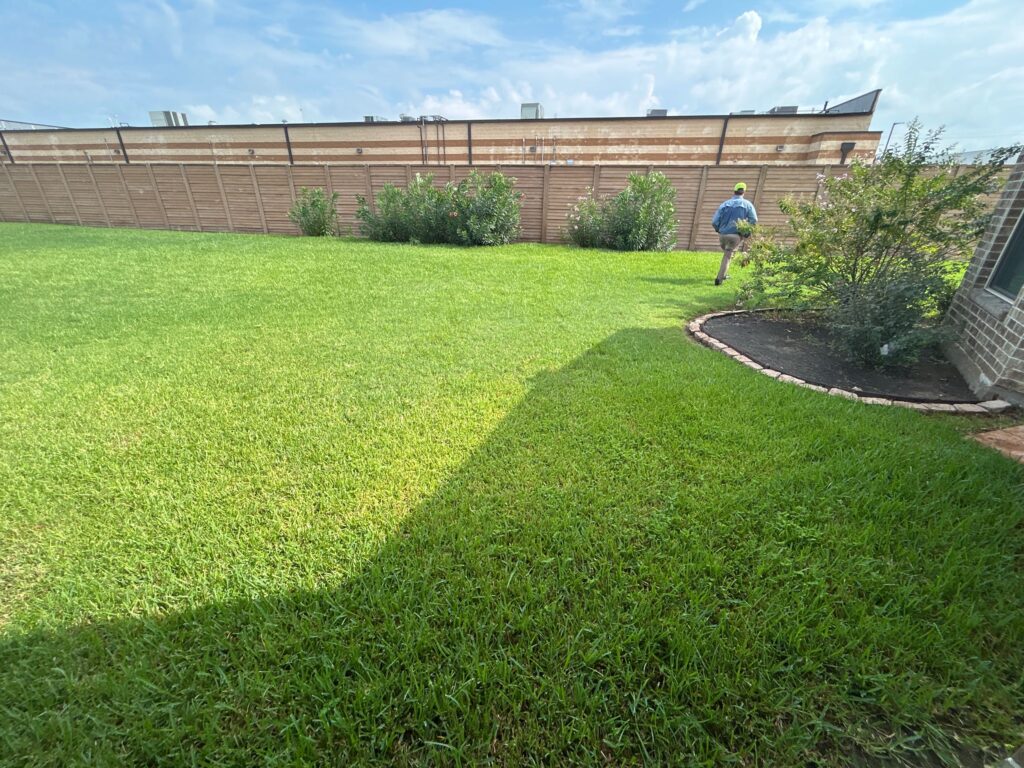 GreenGate Technician completing treatment on a green lawn