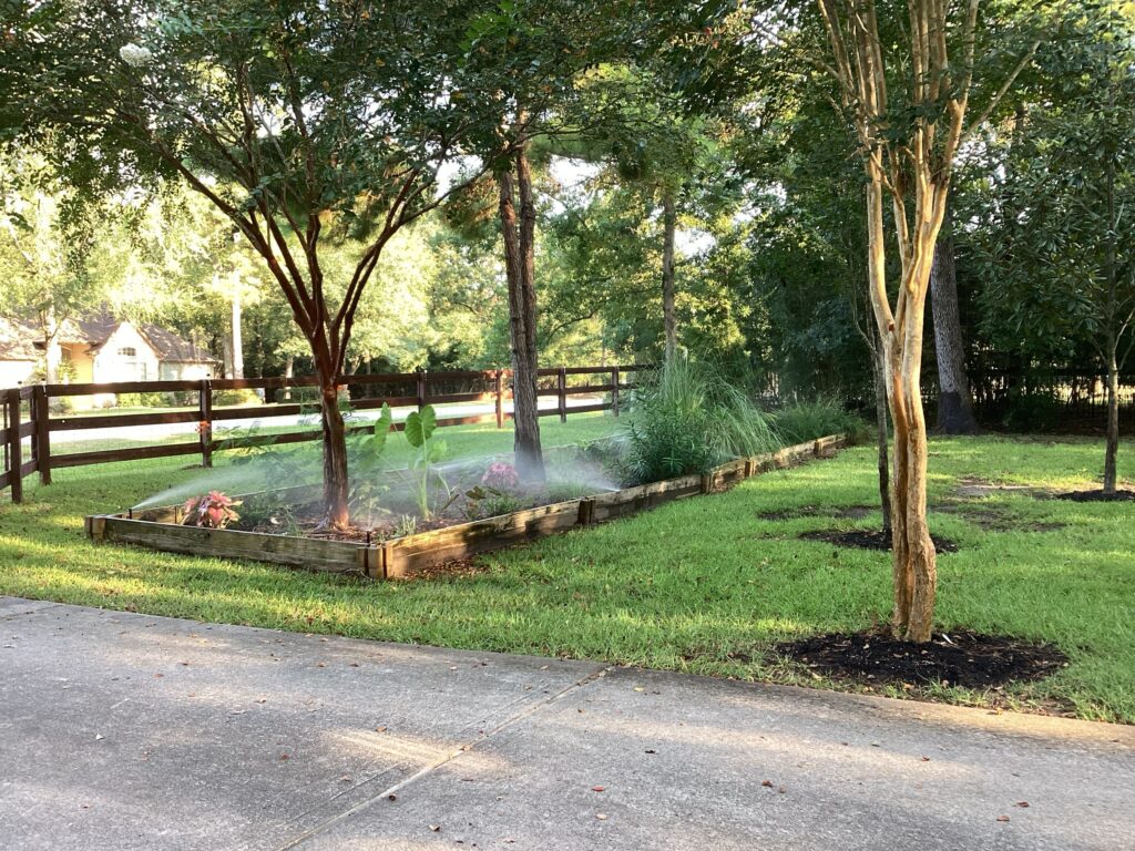 Sprinklers running in a yard serviced by greengate turf & pest | Sprinkler service Stafford, TX