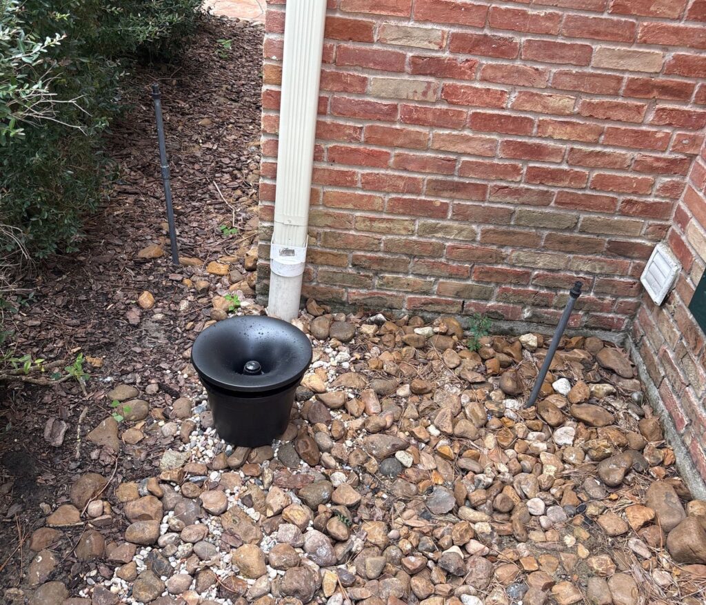 in2care mosquito bucket near shrubs on a property in Kingwood, TX