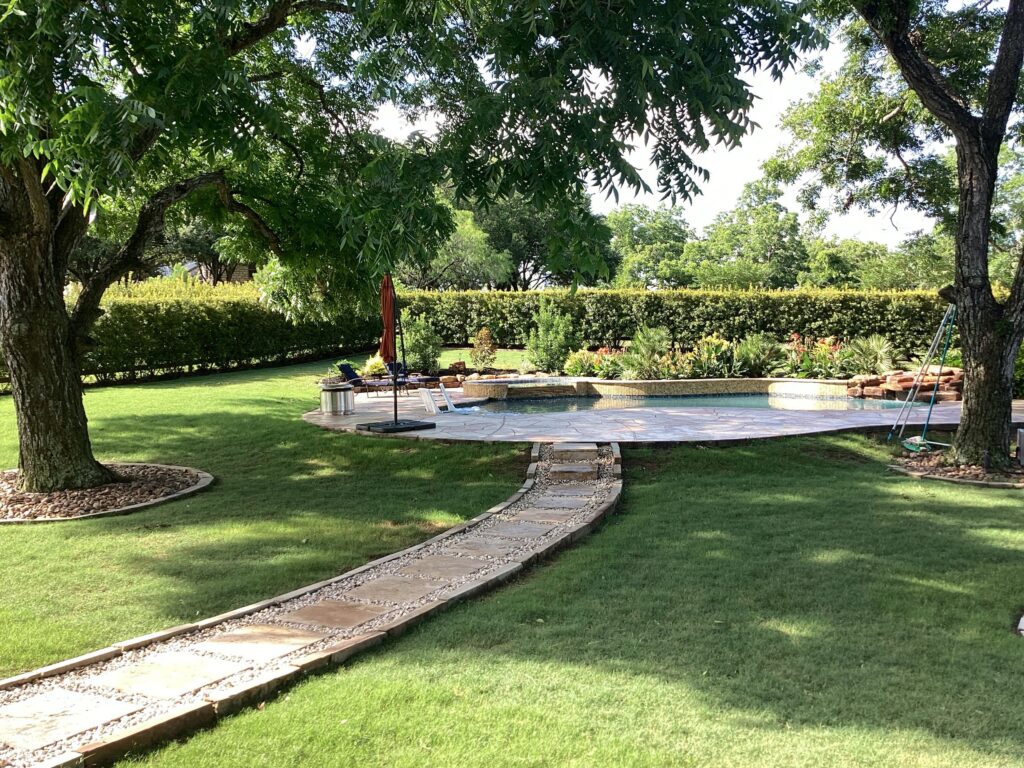 Green lawn and beautiful pool after being treated for mosquito control. Includes mosquito barrier spray and in2care mosquito traps