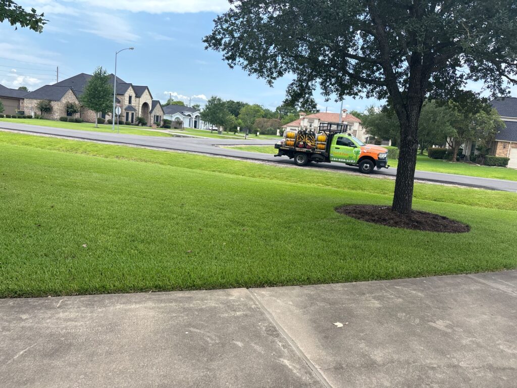 GreenGate truck in front of a green lawn after a lawn pest control service in Porter, TX