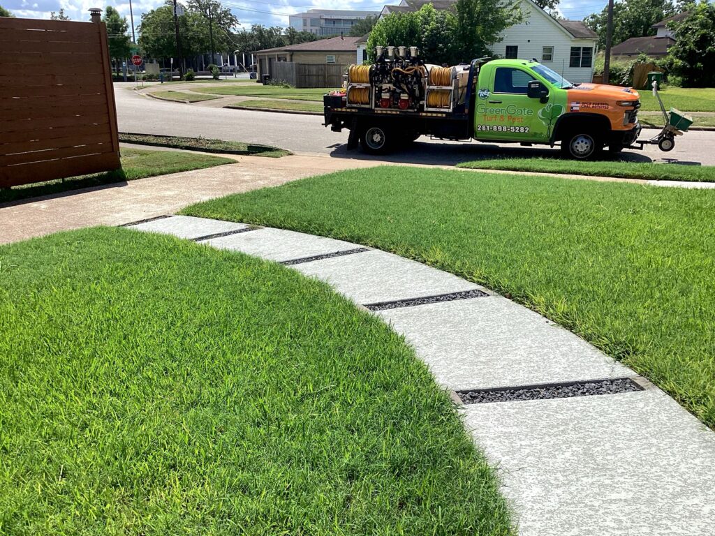 Greengate truck parked in front of a green lawn