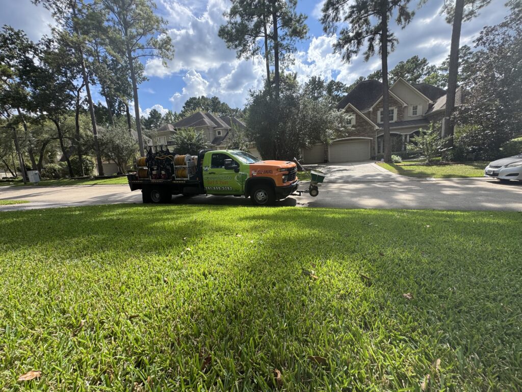 Greengate truck parked in front of a lawn receiving sod webworm treatment