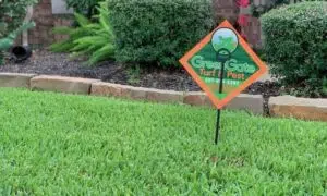 Close up shot of a greengate sign in a green lawn after a lawn fertilizer service; local lawn care services