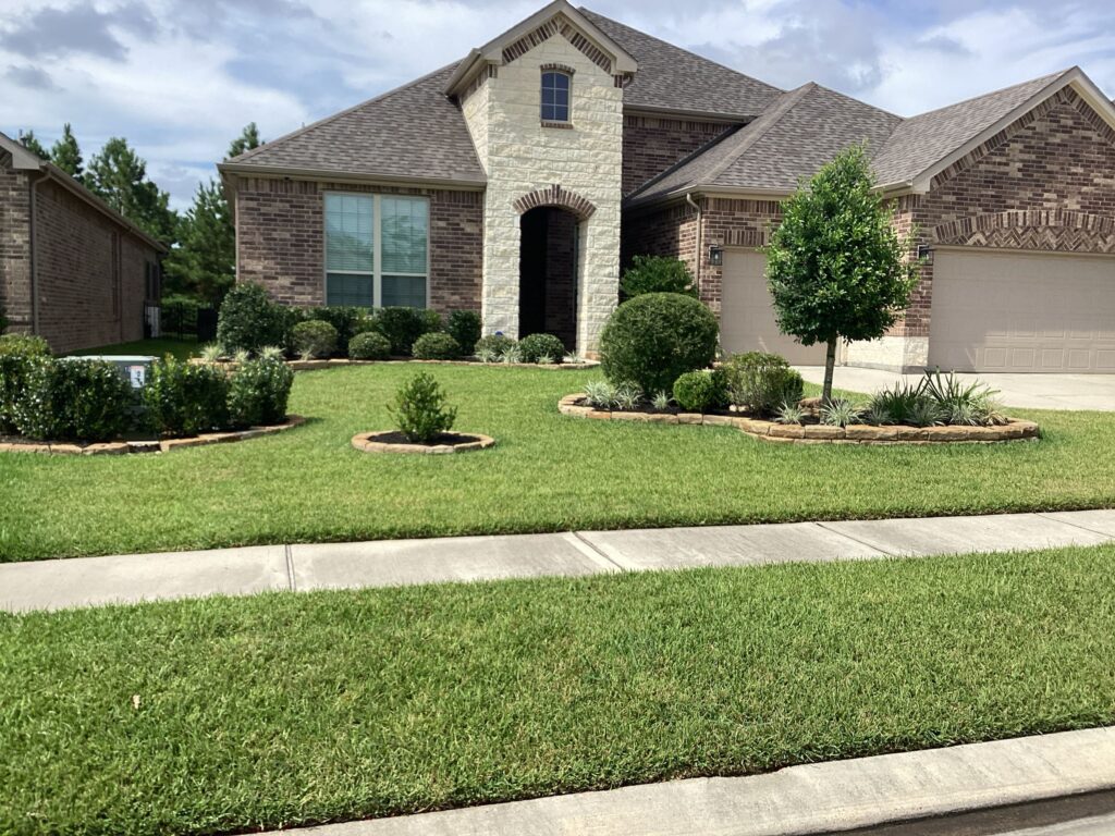 A brick home and a large front lawn after a perimeter pest control spray